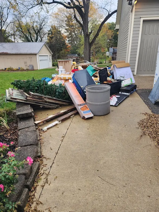 Dumpster being loaded with debris for 12 Yard Dumpster Rental in Webster